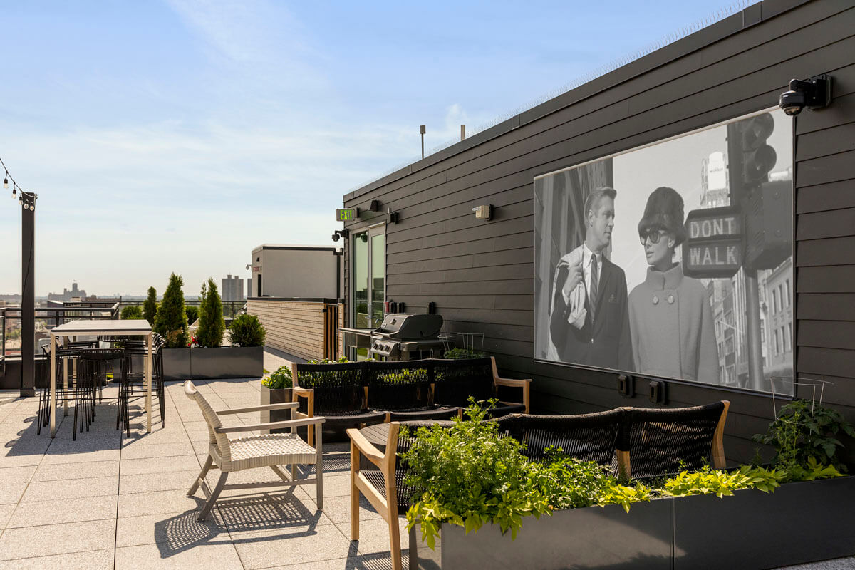 View of rooftop entertainment area showing movie screen and seating