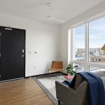 View of studio apartment with modern decor, floor to ceiling windows and efficient use of space