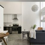 view of lower level of loft apartment with open concept kitchen and living room