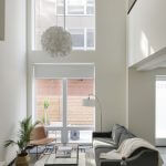 view of lower level of loft apartment living room and exterior door
