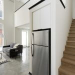 View of lower floor of loft apartment open concept kitchen and living room